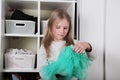 Young girl choosing dress in wardrobe at home. The wardrobe which put in order. All things are folded neatly. Many boxes. Everythi Royalty Free Stock Photo