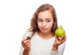 Young girl choosing between fruit and chocolate isolated Royalty Free Stock Photo