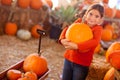 Young Girl Choosing A Pumpkin Royalty Free Stock Photo