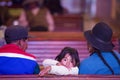 Young girl in church with her family, Tupiza - Bolivia