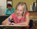 Young girl in class with teacher Royalty Free Stock Photo