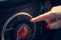 Young girl clicked on the automatic button of the automatic air conditioning control panel with a 25 degree Celsius adjustment. Royalty Free Stock Photo