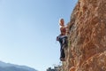 A young girl climber climbs high up the cliff in Geyikbayiri Tur