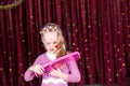 Young Girl Clown Brushing Hair with Large Comb Royalty Free Stock Photo