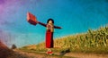 Girl coat with suitcase on a rural road near cornfield