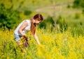 Young girl collecting flowers on field Royalty Free Stock Photo