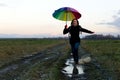 Young emotional woman with an umbrella on a walk, nature light Royalty Free Stock Photo