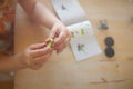 young girl in colorful dress puts togehter parts with her little fingers to build a toy tractor from plastic bricks Royalty Free Stock Photo