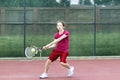 Young girl concentrating on her tennis backhand stroke Royalty Free Stock Photo