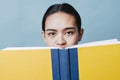 Young Girl is Confused Reading Text Book with Copy Space