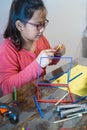 A young girl is constructing with lots of colorful plastic sticks. fun with building geometric figures and learning mathematics at Royalty Free Stock Photo