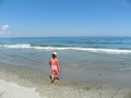 Young girl contemplating the mesmerizing ocean waves Royalty Free Stock Photo