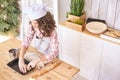 Young girl cooking at kitchen. Curly pretty child portrait. Chef student Royalty Free Stock Photo