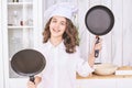 Young girl cooking kitchen. Curly pretty child portrait. Chef christmas student Royalty Free Stock Photo