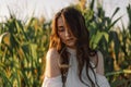 A young girl in a cornfield with a spike of wheat in your mouth. Unity with nature Royalty Free Stock Photo