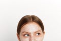 Young girl cosmetic mask of clay on her face looking aside