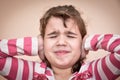 Young girl covering her ears