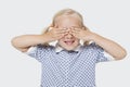 Young girl covering her eyes over white background Royalty Free Stock Photo