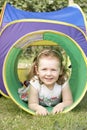 Young Girl Crawling Through Play Equipment