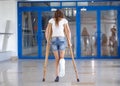 A young girl is on crutches in the corridor of the hospital Royalty Free Stock Photo