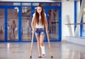 A young girl is on crutches in the corridor of the hospital. Royalty Free Stock Photo