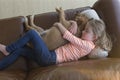 Young girl cuddling her pet dog at home Royalty Free Stock Photo