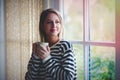 Young girl with cup of coffee stay near window Royalty Free Stock Photo