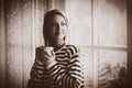 Young girl with cup of coffee stay near window Royalty Free Stock Photo