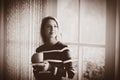 Young girl with cup of coffee stay near window Royalty Free Stock Photo