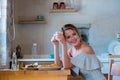 Young girl with cup of coffee or tea on greek kitchen Royalty Free Stock Photo