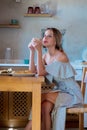 Young girl with cup of coffee or tea on greek kitchen Royalty Free Stock Photo