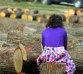 Young girl between cutted tree