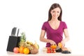 Young girl cutting orange and smiling. Royalty Free Stock Photo