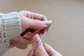 Young girl is cutting with small scissors her nails by herself. Royalty Free Stock Photo