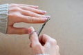 Young girl is cutting with small scissors her nails by herself. Royalty Free Stock Photo