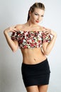 Girl in colorful top, black skirt and uncovered belly Royalty Free Stock Photo