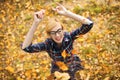 Young girl dancing under falling leaves in the autumn park Royalty Free Stock Photo