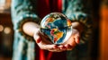 A young girl delicately holds a glass globe in her hands Royalty Free Stock Photo