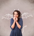 Young girl with devil horns and wings drawing