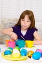 Young girl coloring Easter Eggs Royalty Free Stock Photo