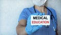 A young girl doctor holds a tablet with an inscription on a medical topic in her hand. Health care concept