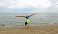 young girl does the gymnastic cartwheeling in the summer