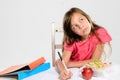 Young girl does her homework on table Royalty Free Stock Photo