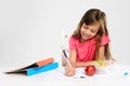 Young girl does her homework on table