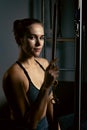 A young girl does Pilates exercises with a bed reformer, barrel machine tool. Portrait shot of a beautiful slim fitness