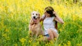 Young girl with dog on blooming meadow Royalty Free Stock Photo