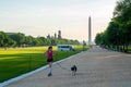 Young girl with a dog doing sports in Washington city near Washington monument on sunny day Royalty Free Stock Photo