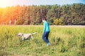 Young girl with dog walking in the field Royalty Free Stock Photo