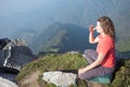 Young girl doing breathing yoga on top.