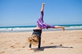 Young girl doing cartwheel at beach